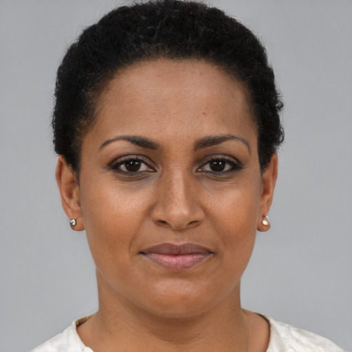 Joyful black adult female with short  brown hair and brown eyes