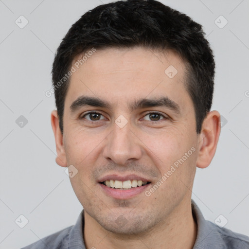 Joyful white young-adult male with short  black hair and brown eyes