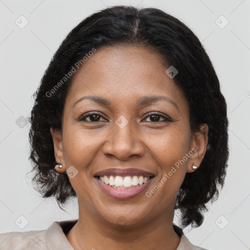 Joyful black adult female with medium  brown hair and brown eyes