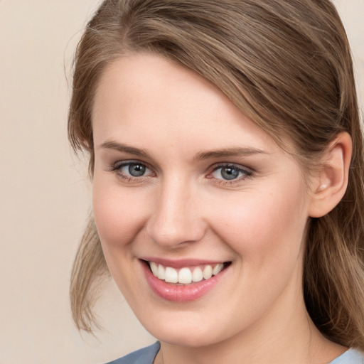 Joyful white young-adult female with long  brown hair and grey eyes