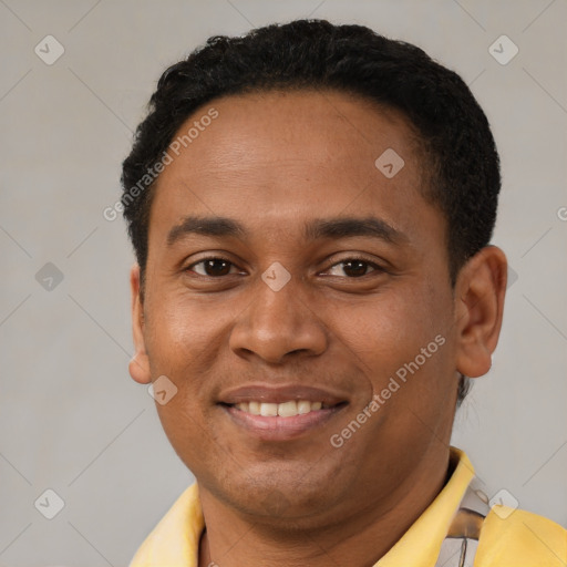 Joyful latino young-adult male with short  brown hair and brown eyes