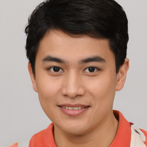 Joyful asian young-adult male with short  brown hair and brown eyes