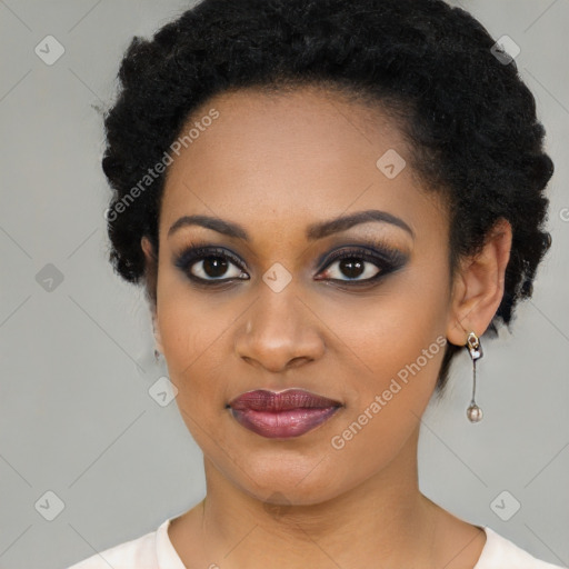 Joyful black young-adult female with short  black hair and brown eyes