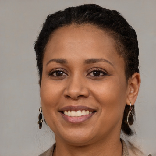Joyful black young-adult female with medium  brown hair and brown eyes