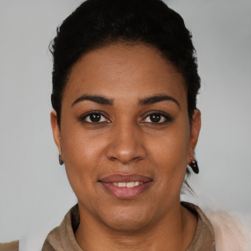 Joyful latino young-adult female with short  black hair and brown eyes