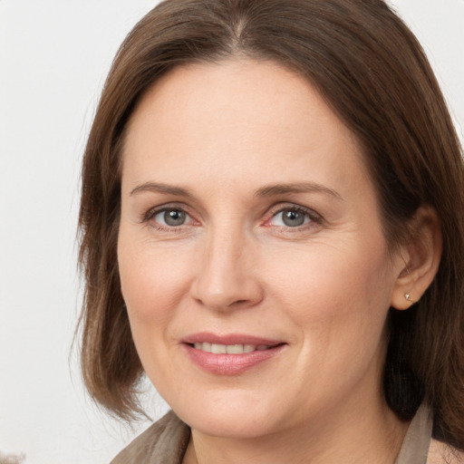 Joyful white adult female with long  brown hair and brown eyes