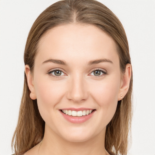 Joyful white young-adult female with long  brown hair and grey eyes