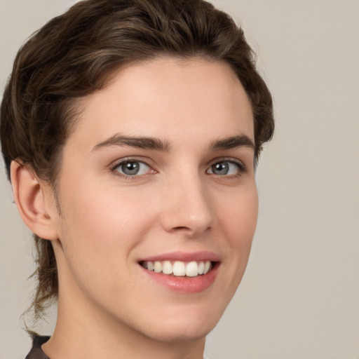 Joyful white young-adult female with short  brown hair and brown eyes