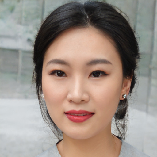 Joyful asian young-adult female with medium  black hair and brown eyes