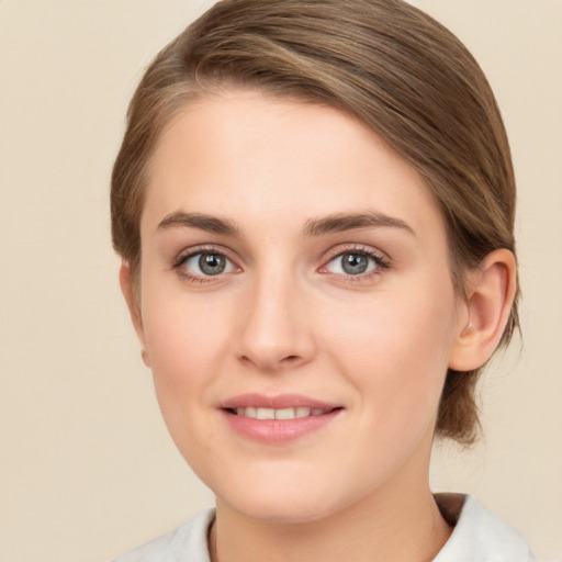 Joyful white young-adult female with medium  brown hair and green eyes