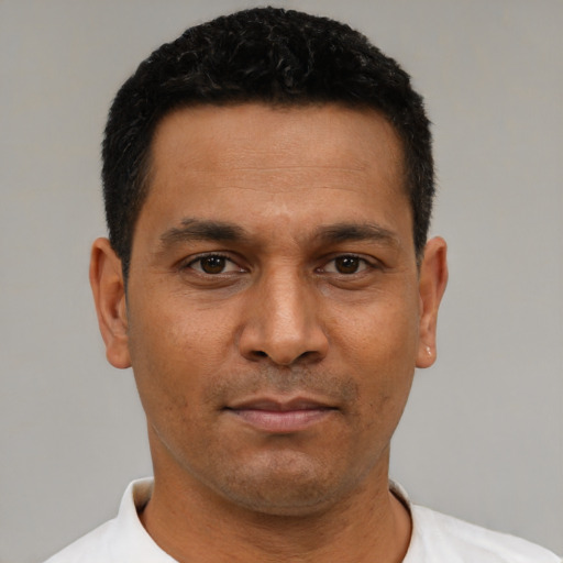 Neutral latino adult male with short  black hair and brown eyes