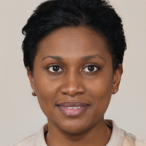 Joyful latino young-adult female with short  black hair and brown eyes
