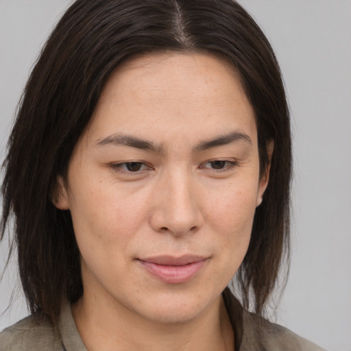 Joyful asian adult female with medium  brown hair and brown eyes