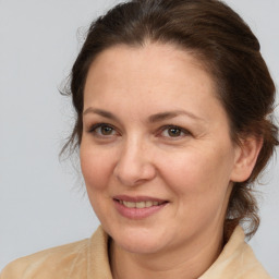 Joyful white adult female with medium  brown hair and brown eyes