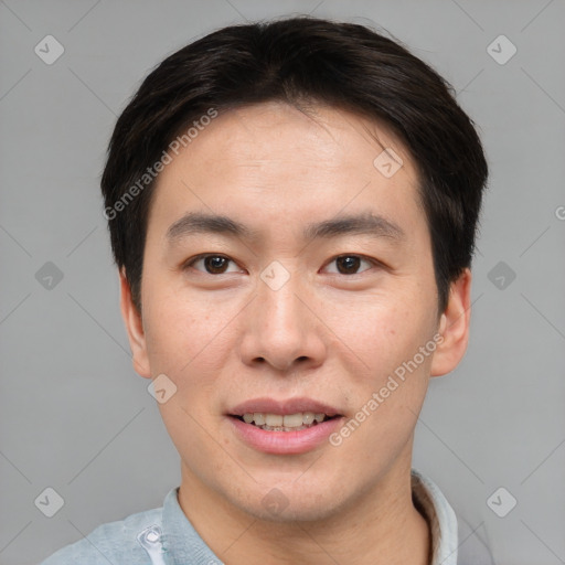 Joyful asian young-adult male with short  brown hair and brown eyes