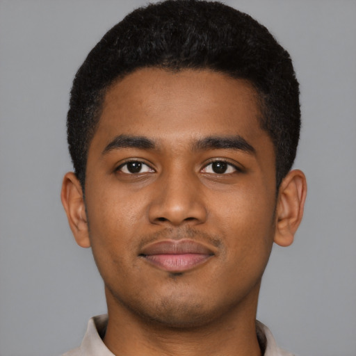 Joyful black young-adult male with short  black hair and brown eyes