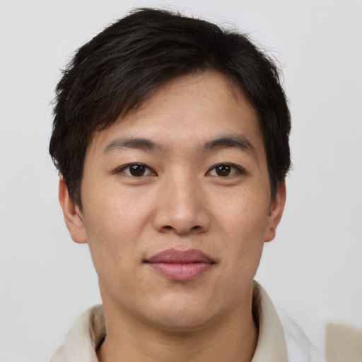 Joyful asian young-adult male with short  brown hair and brown eyes