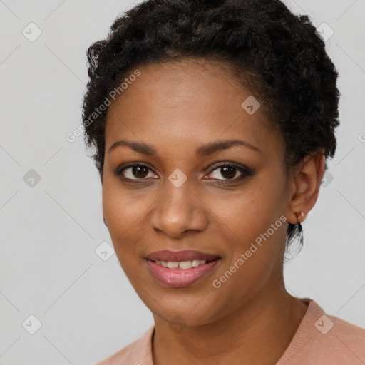 Joyful black young-adult female with short  brown hair and brown eyes