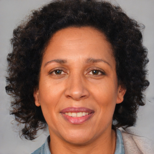 Joyful black adult female with medium  brown hair and brown eyes