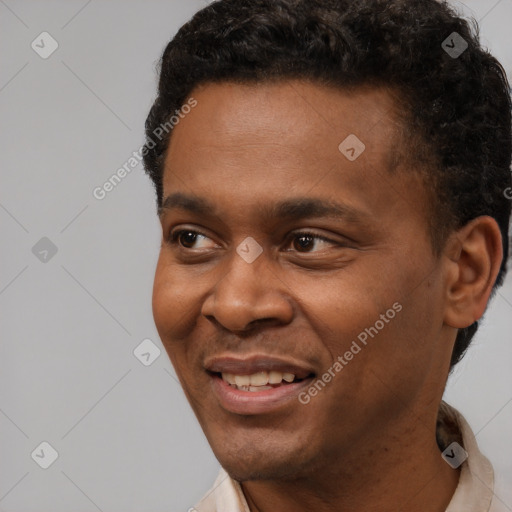 Joyful black young-adult male with short  black hair and brown eyes