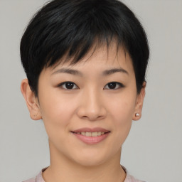 Joyful asian young-adult female with short  brown hair and brown eyes