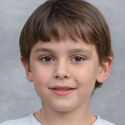 Joyful white child male with short  brown hair and brown eyes