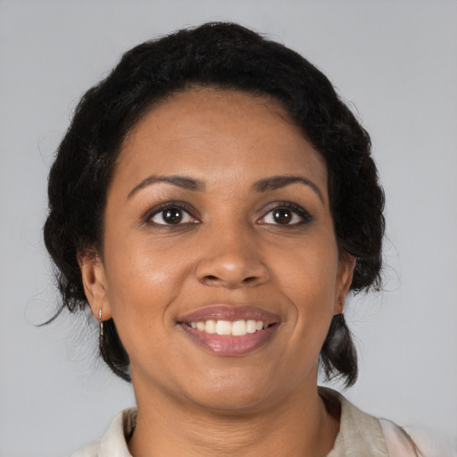 Joyful black young-adult female with medium  brown hair and brown eyes