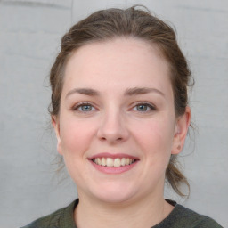 Joyful white young-adult female with medium  brown hair and grey eyes