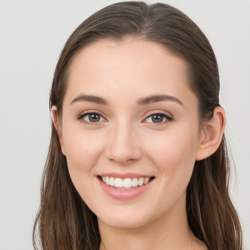 Joyful white young-adult female with long  brown hair and grey eyes