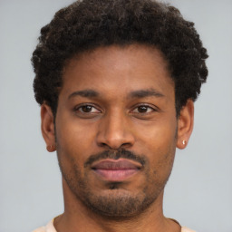 Joyful latino young-adult male with short  brown hair and brown eyes