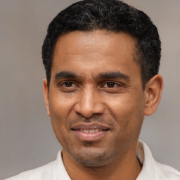 Joyful latino adult male with short  black hair and brown eyes