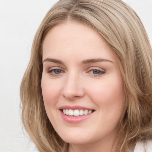 Joyful white young-adult female with long  brown hair and green eyes