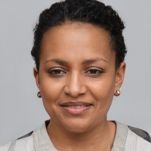 Joyful black young-adult female with short  brown hair and brown eyes
