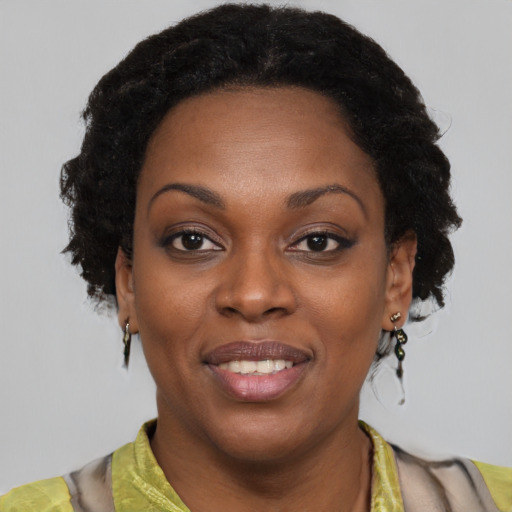 Joyful black young-adult female with short  brown hair and brown eyes