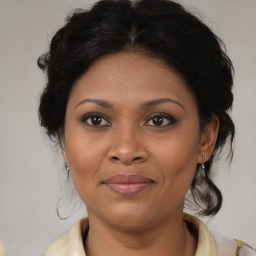 Joyful black adult female with medium  brown hair and brown eyes