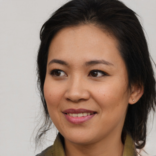 Joyful asian young-adult female with medium  brown hair and brown eyes
