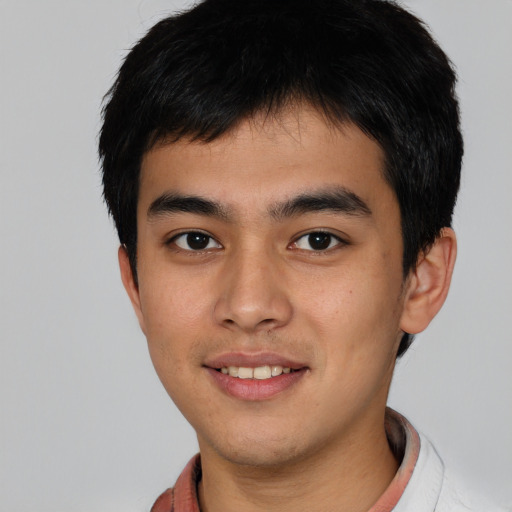 Joyful asian young-adult male with short  black hair and brown eyes