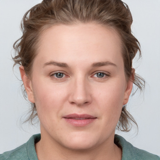 Joyful white young-adult female with medium  brown hair and blue eyes