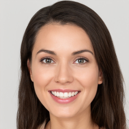 Joyful white young-adult female with long  brown hair and brown eyes