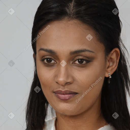 Joyful black young-adult female with long  brown hair and brown eyes