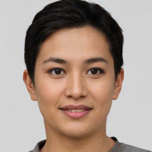 Joyful asian young-adult female with short  brown hair and brown eyes