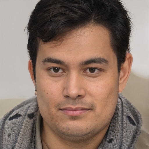Joyful latino young-adult male with short  brown hair and brown eyes