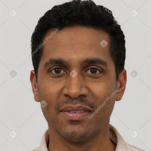 Joyful black young-adult male with short  black hair and brown eyes