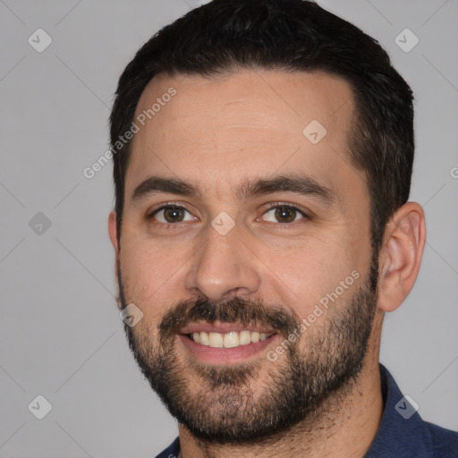 Joyful white young-adult male with short  black hair and brown eyes