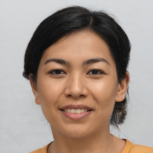 Joyful asian young-adult female with short  black hair and brown eyes