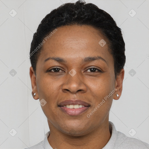 Joyful black young-adult female with short  black hair and brown eyes