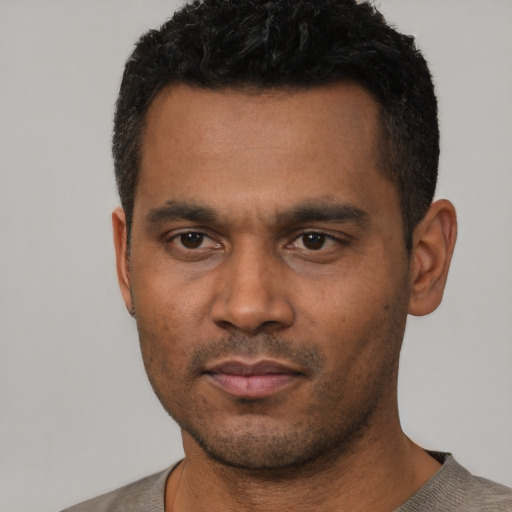 Neutral latino young-adult male with short  black hair and brown eyes