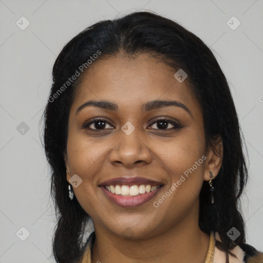 Joyful black young-adult female with long  black hair and brown eyes