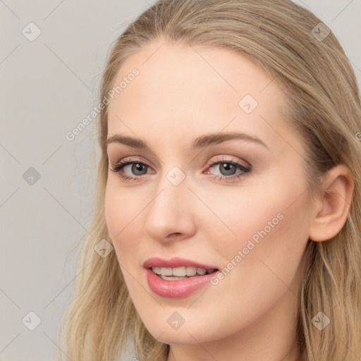 Joyful white young-adult female with long  brown hair and blue eyes