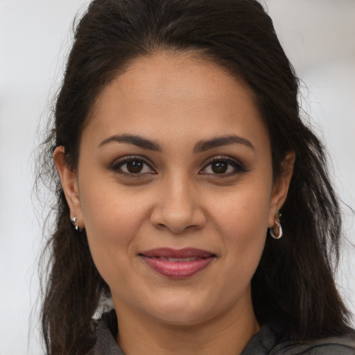Joyful white young-adult female with long  brown hair and brown eyes